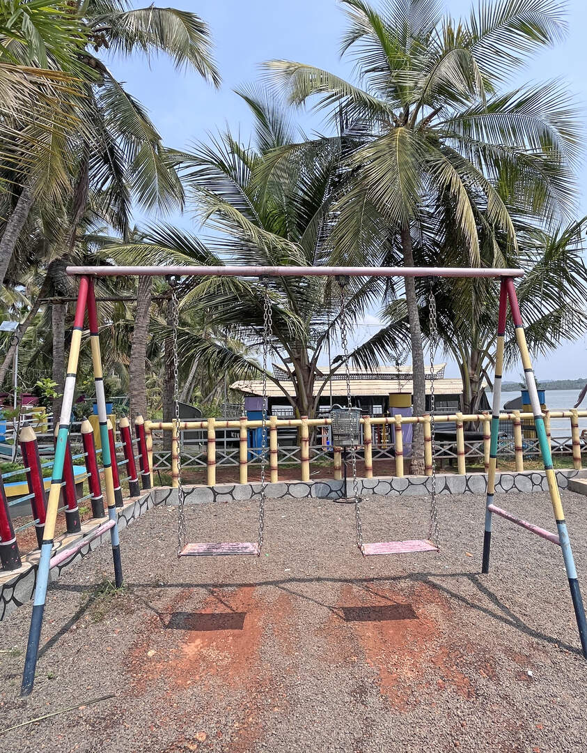 Playground swing set for kids at Akalappuzha Park